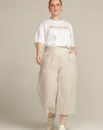 Plus sized woman wears beige linen culottes