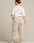 Back view of a plus sized woman wearing beige linen culottes