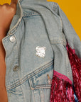 Courage is found in unlikely places enamel pin on a denim jacket