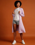 Curly haired woman in lilac cardigan