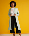 Curly haired woman in mint cardigan
