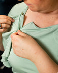 close up woman opening zip on adaptive top for chemotherapy cancer treatment