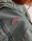 Nevertheless She Persisted enamel pin on denim jacket