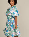 brown woman wearing an adaptive printed ruffle dress