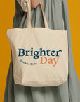 Close up natural tote bag with Brighter Day Smile in Style design