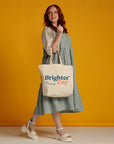 Woman walking with natural Brighter Day tote bag
