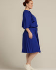 Side view plus sized woman in royal blue dress with port access