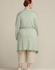 Back view plus size woman in mint cardigan