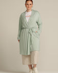Plus size woman in mint cardigan