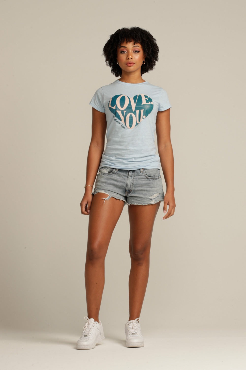 Curly haired woman wears blue LOVE YOU tee