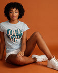 Woman wearing Love you Brighter Day blue heart tee