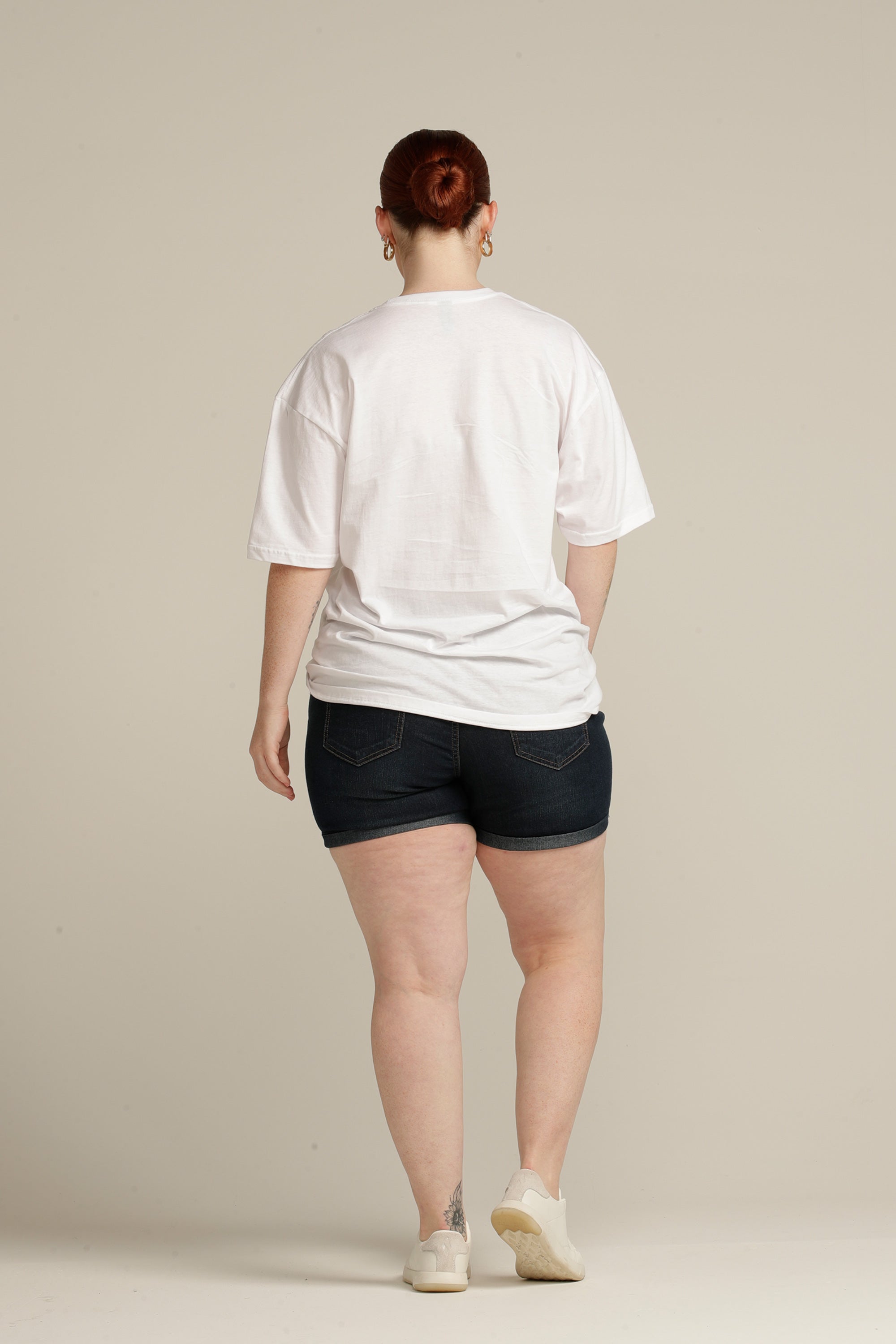 Back view of plus size woman wearing white tee