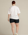 Back view of plus size woman wearing white tee