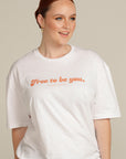 Red Haired woman wears white Free To Be You tee