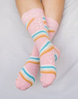 Close up of woman wearing pink socks with rainbows