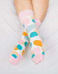 Close up of woman wearing socks with coloured spots