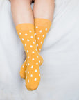 Close up of woman wearing yellow socks with white spots