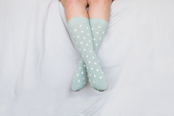 Close up of woman wearing mint socks with white spots