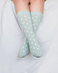 Close up of woman wearing mint socks with white spots