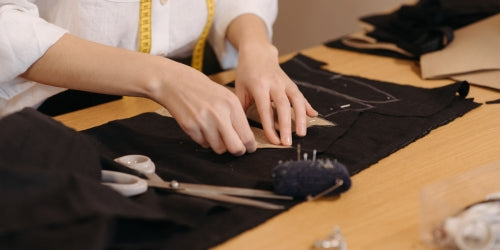 Adaptive clothing made in Australia, a piece of black fabric on a table being cut