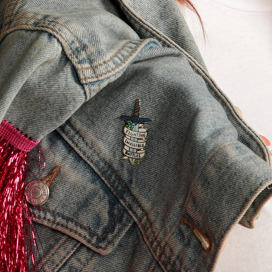 Fighting invisible battles enamel pin on denim jacket