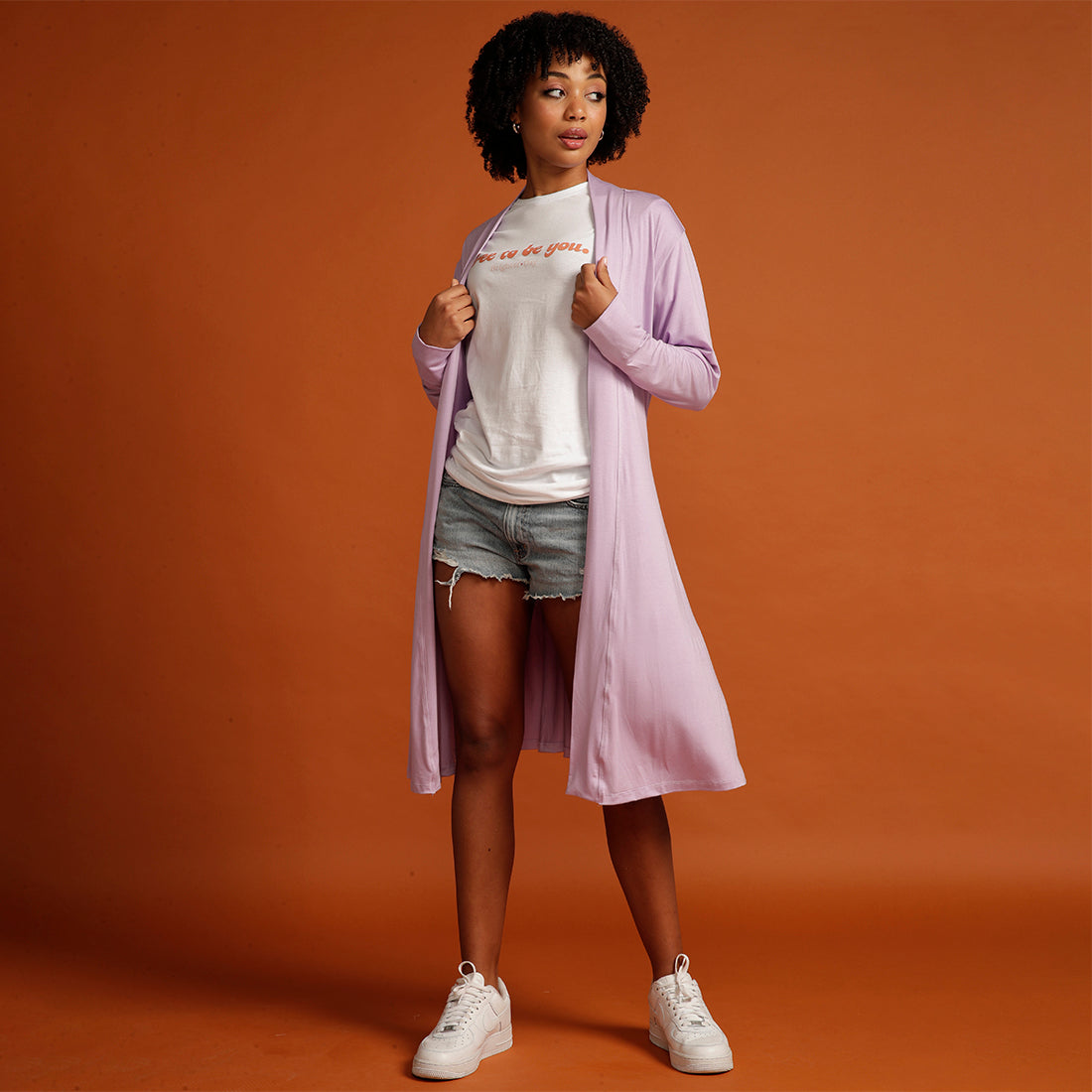 Curly haired woman in lilac cardigan