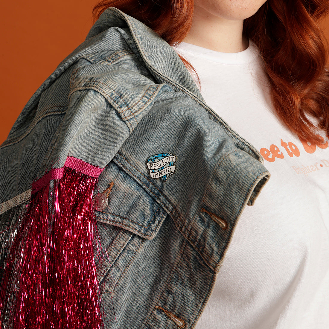 Perfectly Imperfect enamel pin on denim jacket