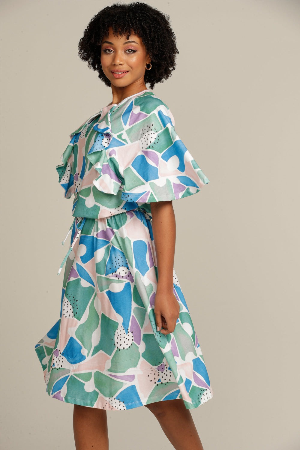 brown woman wearing an adaptive printed ruffle dress