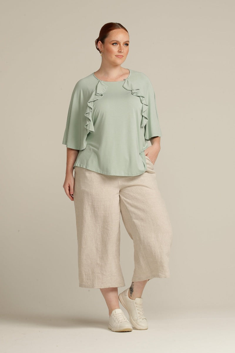 plus size woman in mint green top with port access detail
