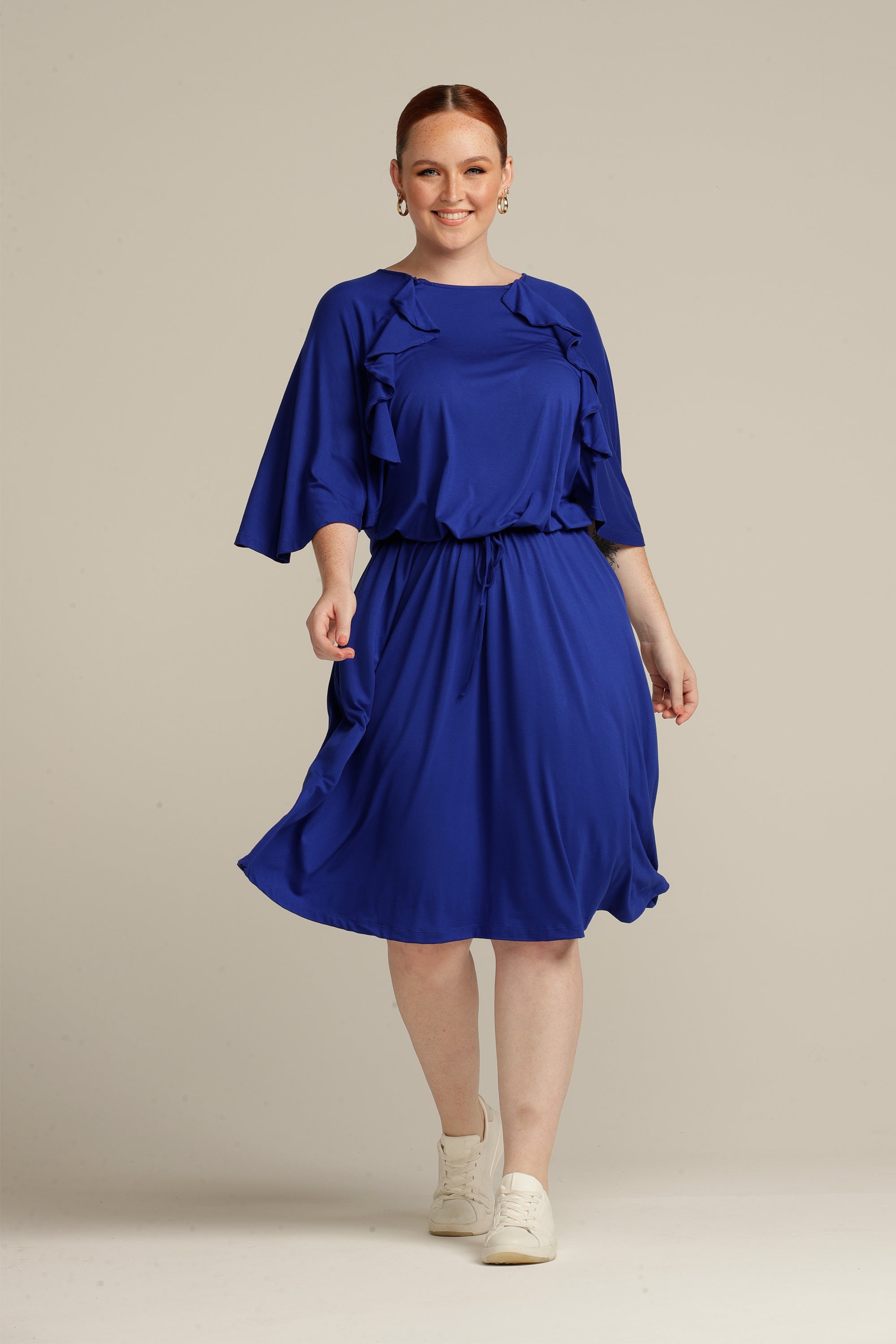 Plus sized woman walking in royal blue dress with port access