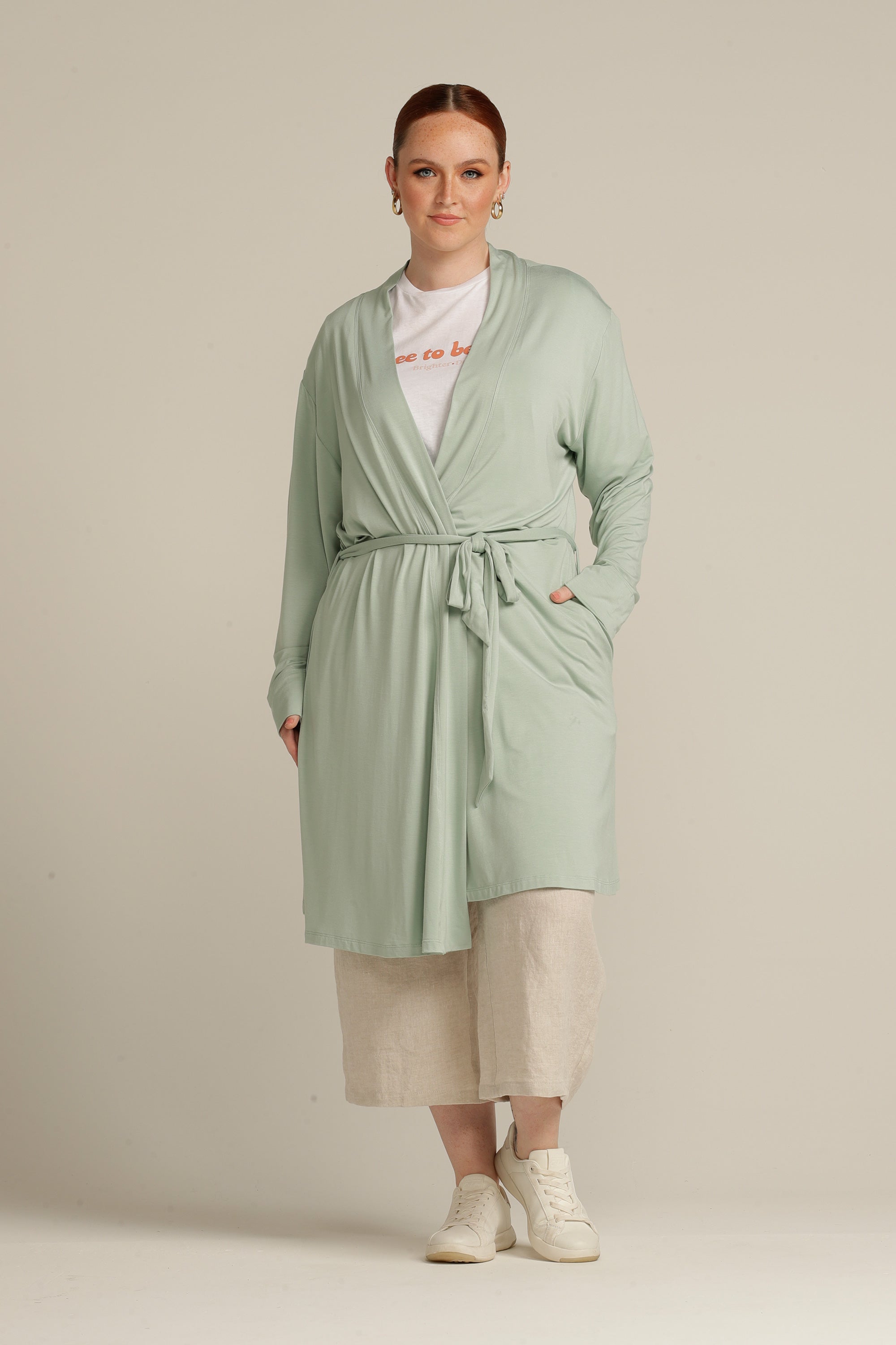 Plus size woman in mint cardigan