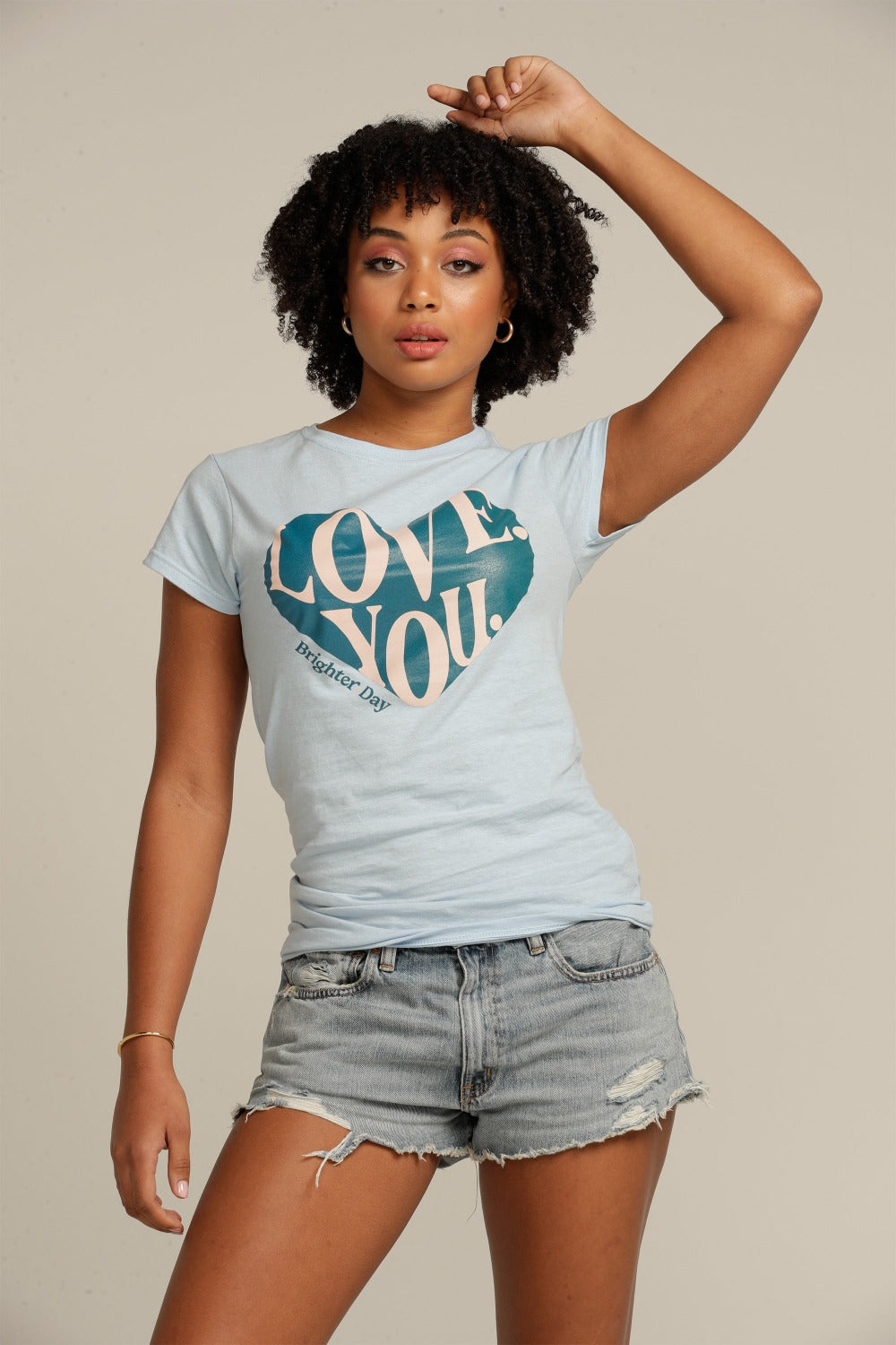 Curly haired woman wears blue LOVE YOU fitted tee shirt