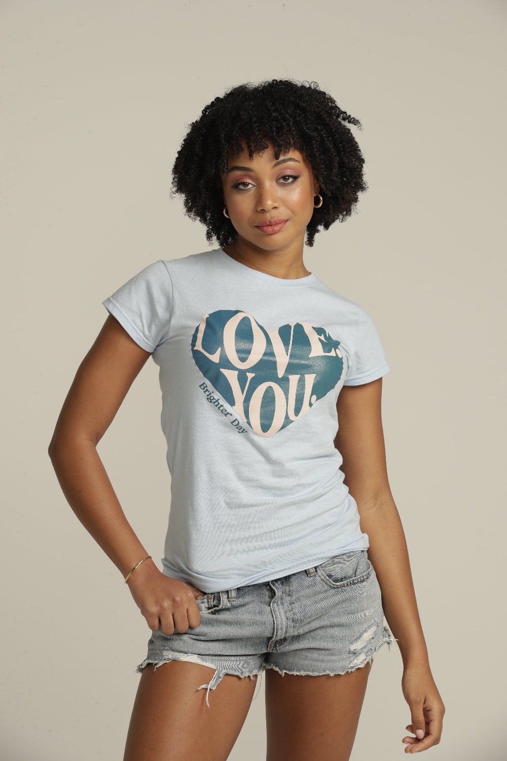 Close up of curly haired woman wearing blue LOVE YOU t-shirt