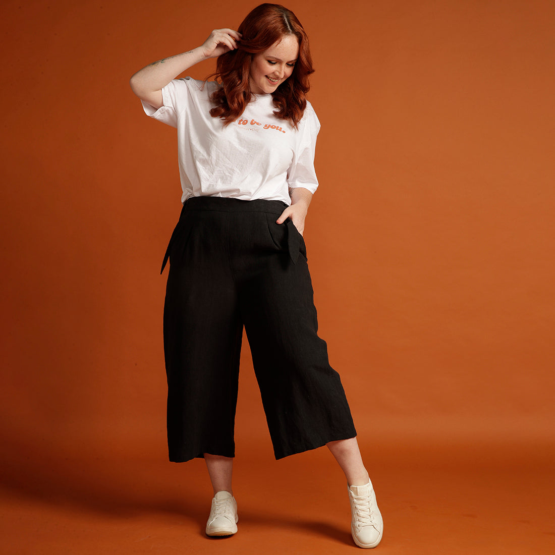 Red-haired woman in black womens culottes