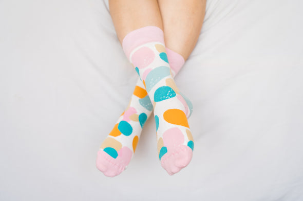 Close up of woman wearing socks with coloured spots
