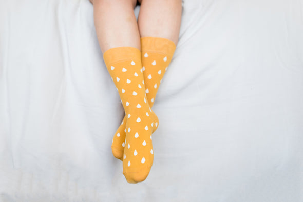 Close up of woman wearing yellow socks with white spots