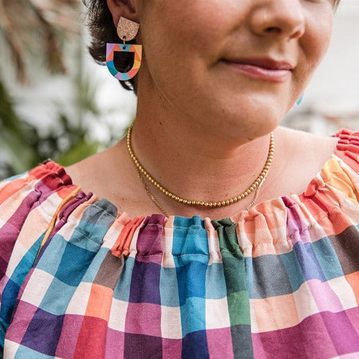 colourful earrings with gold sparkly top and colourful rainbow shape